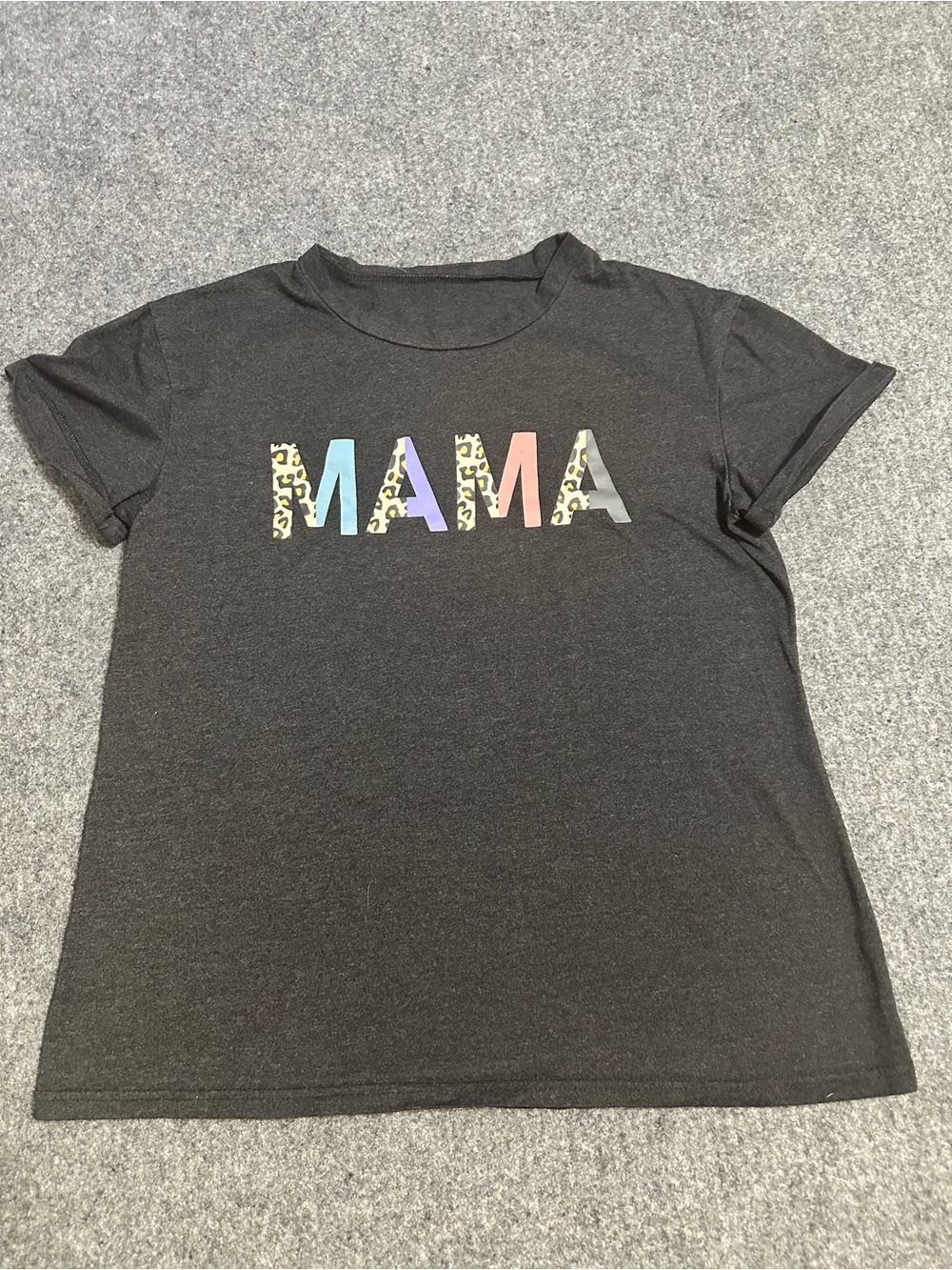This is a dark charcoal short-sleeve t-shirt featuring the word "MAMA".